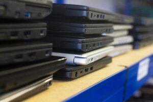 A close up of stacks of laptops on a shelf